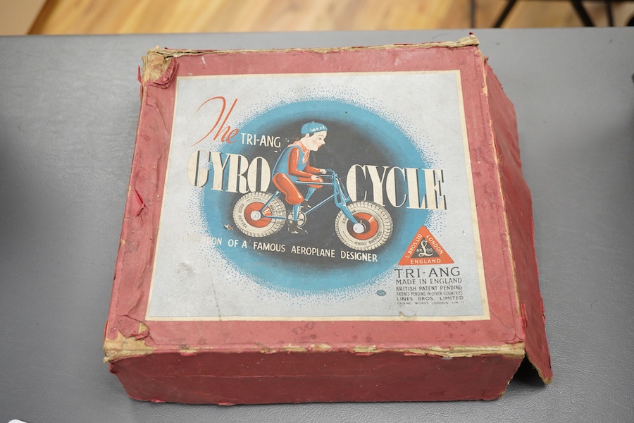 An early boxed Tri-ang Gyro-Cycle, with a gyroscope contained within the front wheel of the bicycle, providing power to the toy, template bicycle with celluloid rider, the box with original inner card holder and a sealed